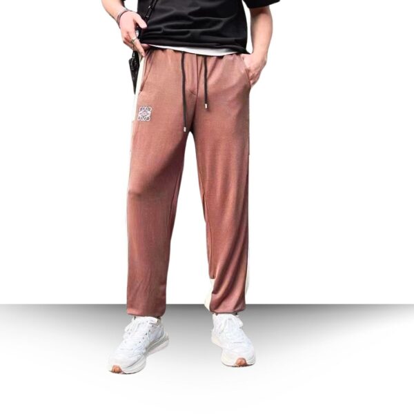 Embrace the pinnacle of elegance with this ensemble: a man showcasing the exclusive Loewe Jogger Pants paired with a classic white shirt