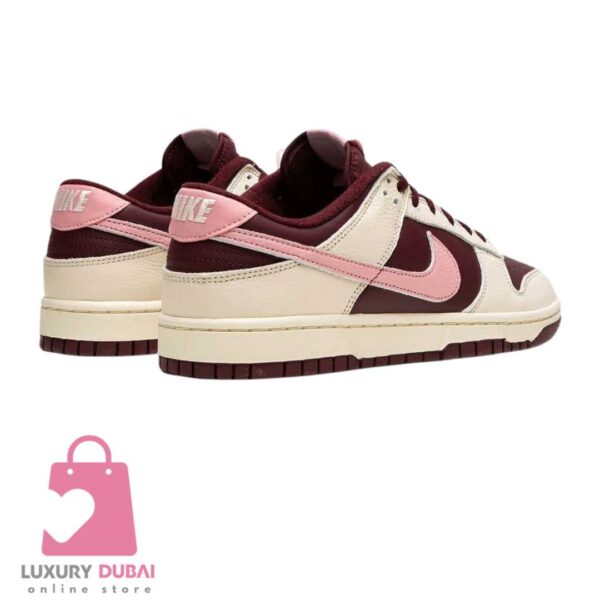 Step into luxury with the Nike Dunk Low in pink and burgundy, a must-have for fashion enthusiasts. Don't miss out on the limited edition Valentines Day release